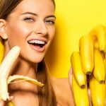 Beautiful young woman with bananas. Tropical fruits. Summer conc